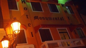 A hotel facade with the name 'Monumental' prominently displayed. - Hotel Monumental (Santo Domingo)