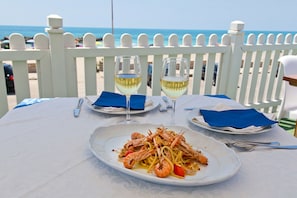 Dine by the sea with a view, surrounded by the essentials for a romantic meal.