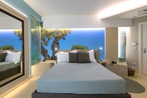 Relax in a spacious room with a large bed, two nightstands, and a large mirror.