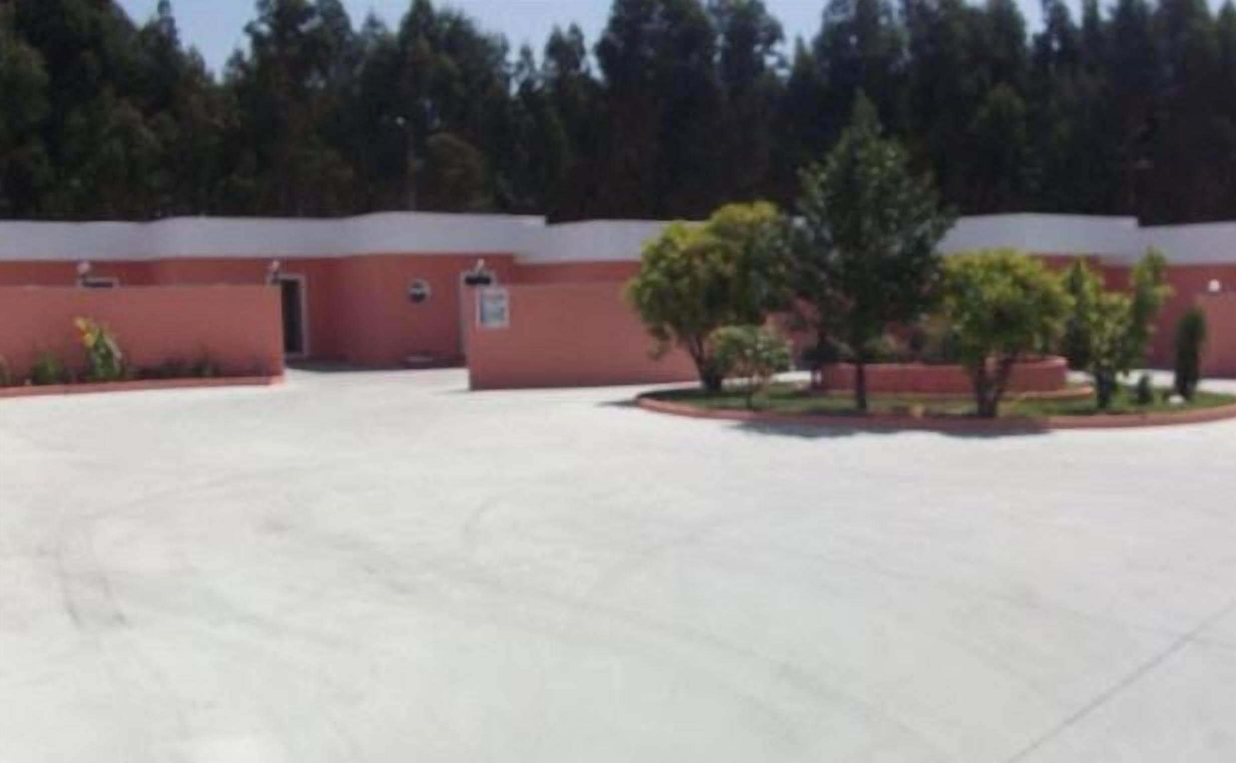 A parking lot with a building in the background.