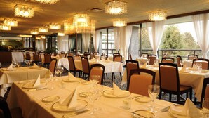 A restaurant with multiple tables set for dining, featuring chandeliers and large windows. - Marroad Hakone (Hakone)