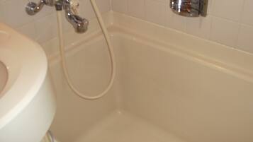 Un baño con bañera, lavamanos y ducha.