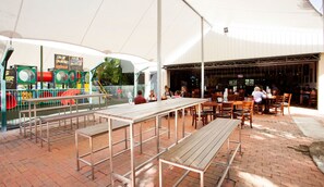 Enjoy family-friendly dining under the stars with a variety of seating options and a nearby play area for kids.
