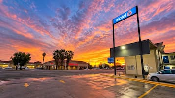 A motel with a clear sky and sunset.