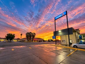A motel with a clear sky and sunset.