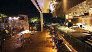 An outdoor bar area with wooden flooring and seating. - Grand Earl Hotel (Douliou)