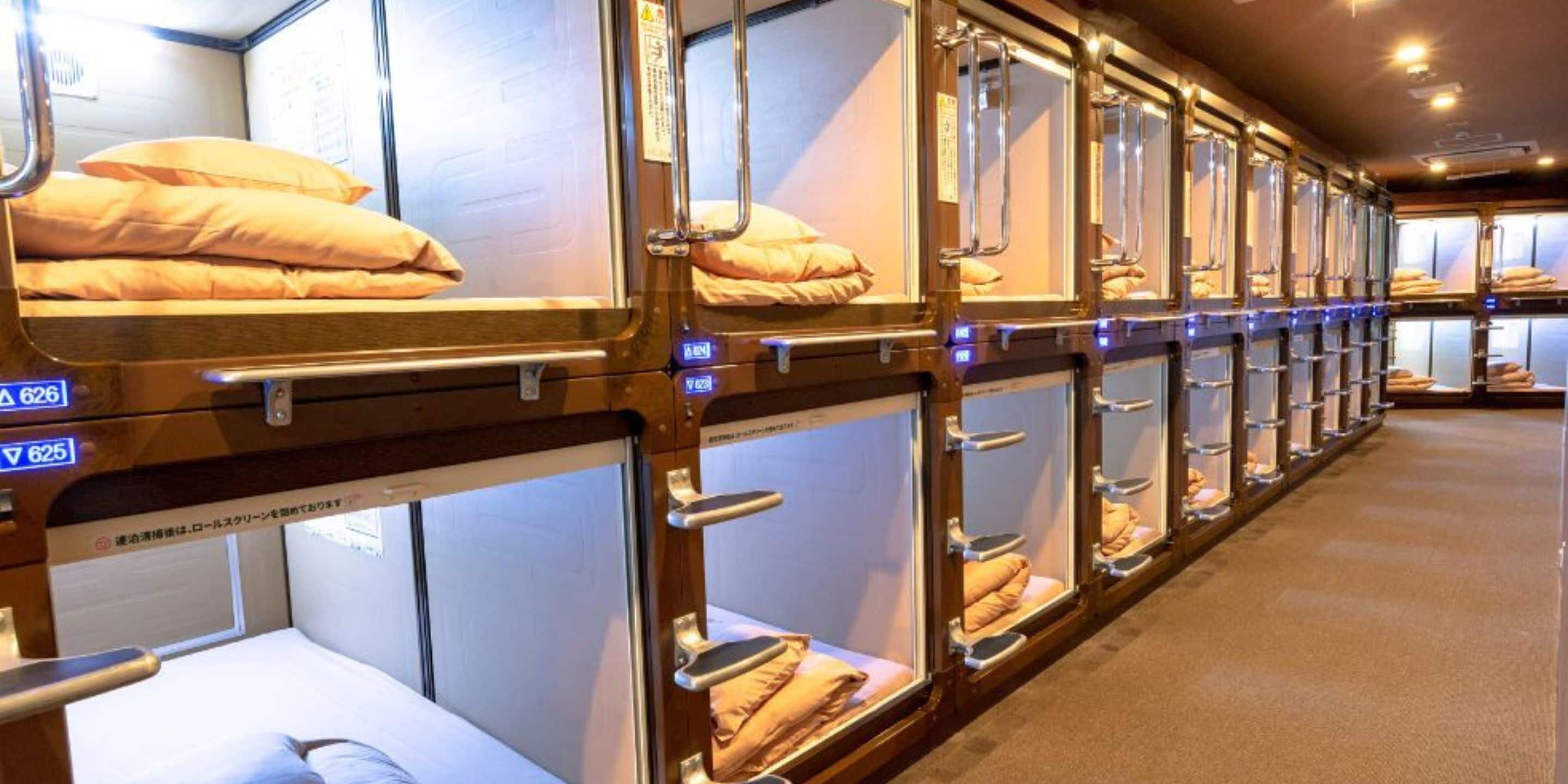 A train car with multiple berths, each with a bed and a window.