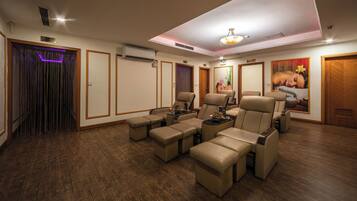 Relax in a stylish room with a seating area, air conditioning, and comfortable chairs.
