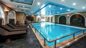 A large indoor swimming pool with a ceiling mural, stone walls, and a statue. - A25 Signature Hotel (Hanoi)