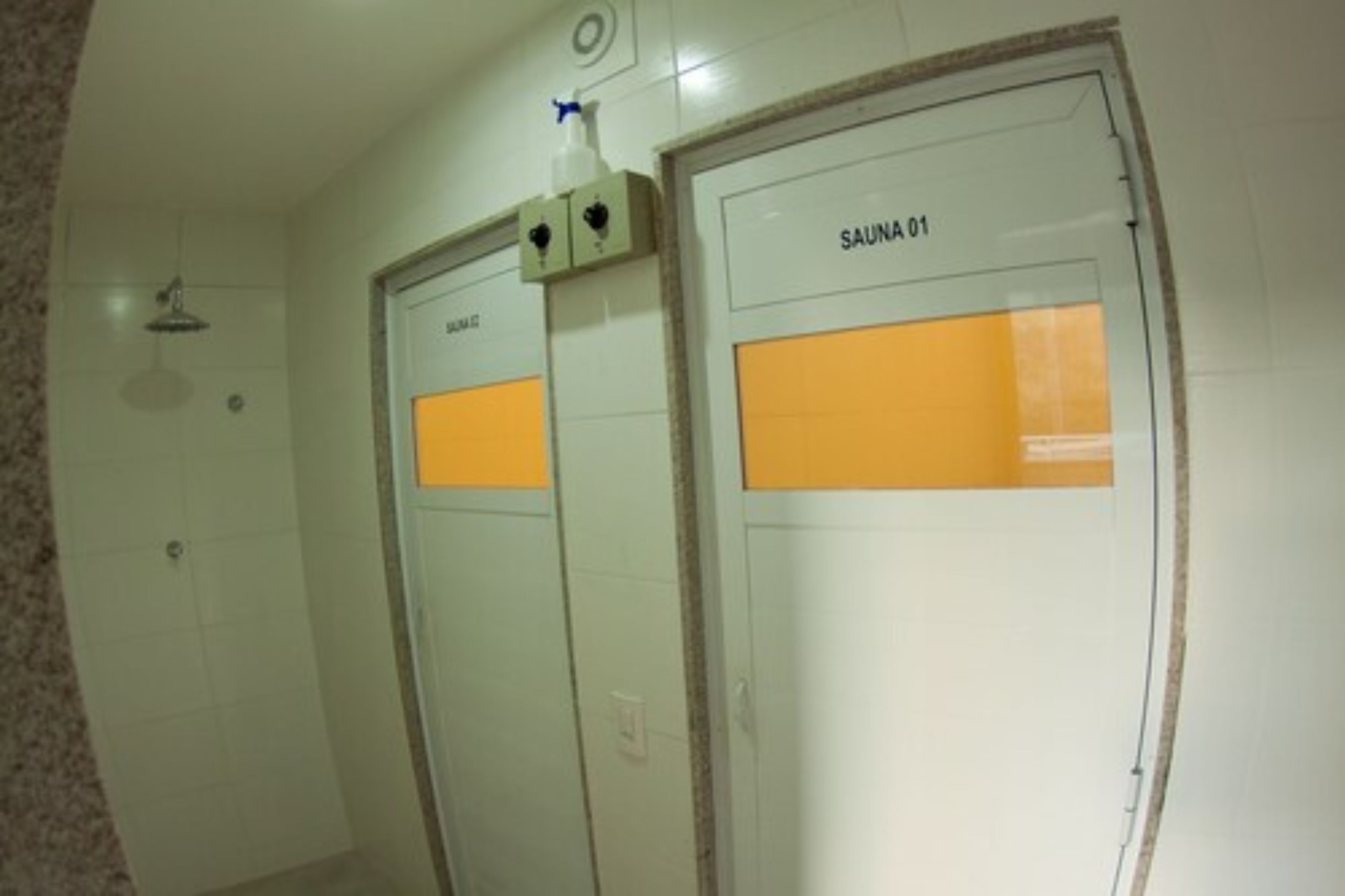 A sauna room with two doors labeled "SAUNA 01" and "SAUNA 02".