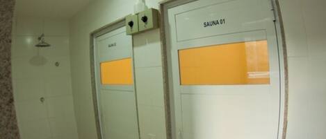 A sauna room with two doors labeled "SAUNA 01" and "SAUNA 02".