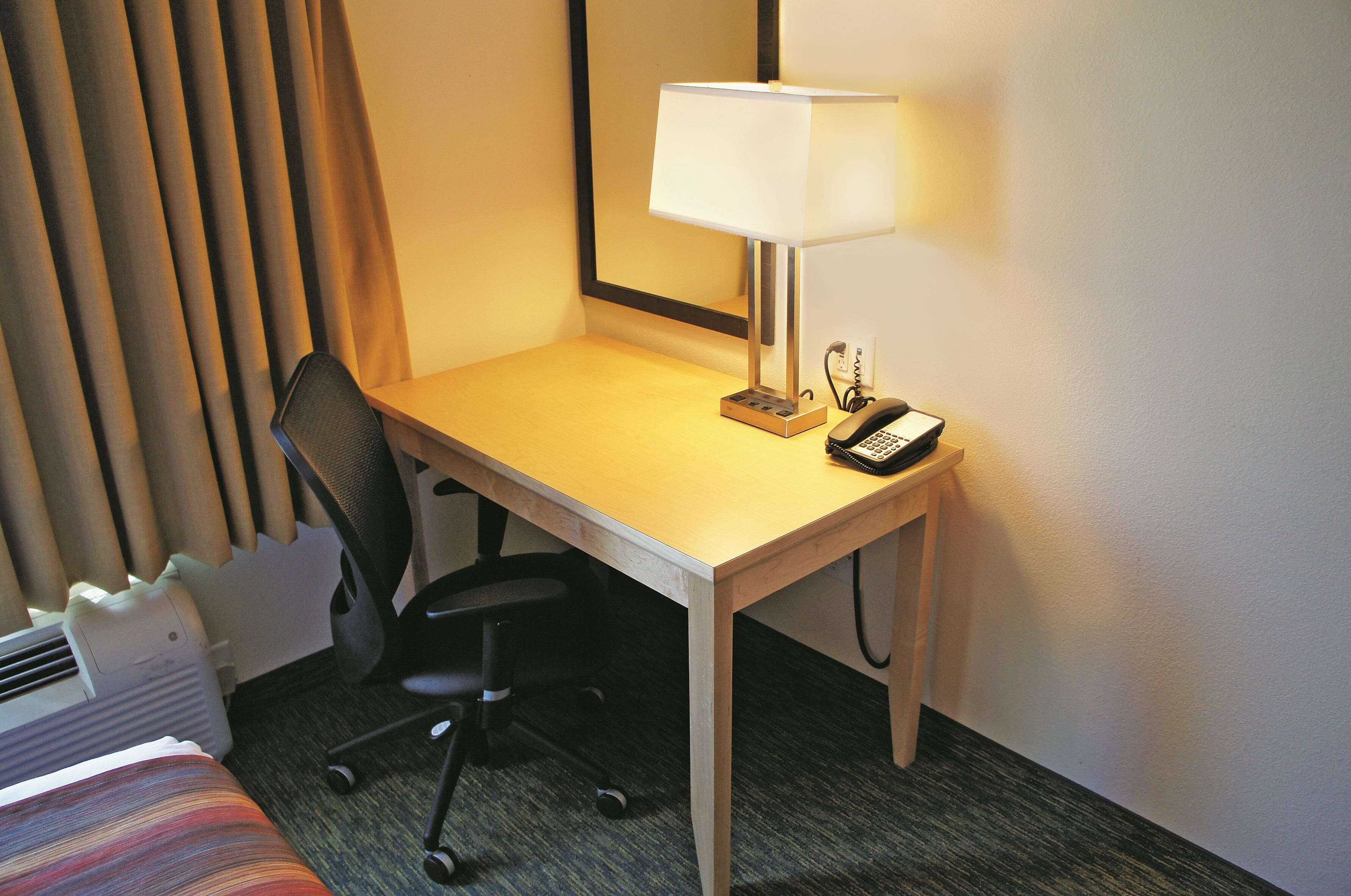 premium bedding, desk, laptop workspace, blackout curtains