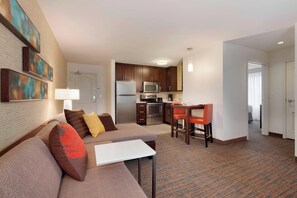 A hotel room with a living area, kitchenette, and a separate dining area. - Residence Inn by Marriott San Angelo (San Angelo)