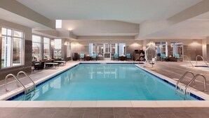 An indoor swimming pool with clear blue water, surrounded by lounge chairs and a sun terrace. - Residence Inn by Marriott San Angelo (San Angelo)