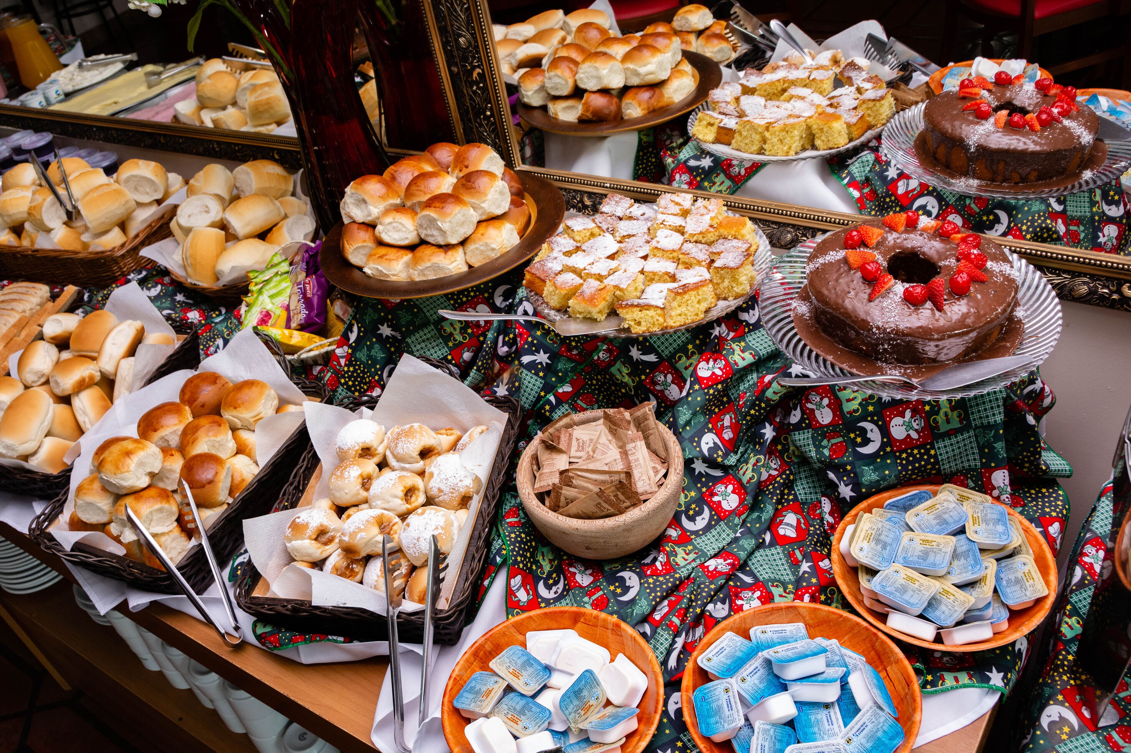A buffet table with various baked goods and desserts.