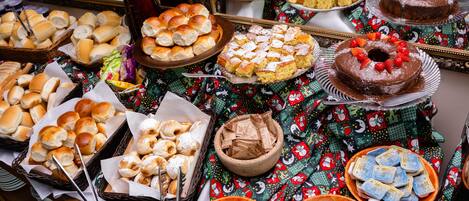 A buffet table with various baked goods and desserts.