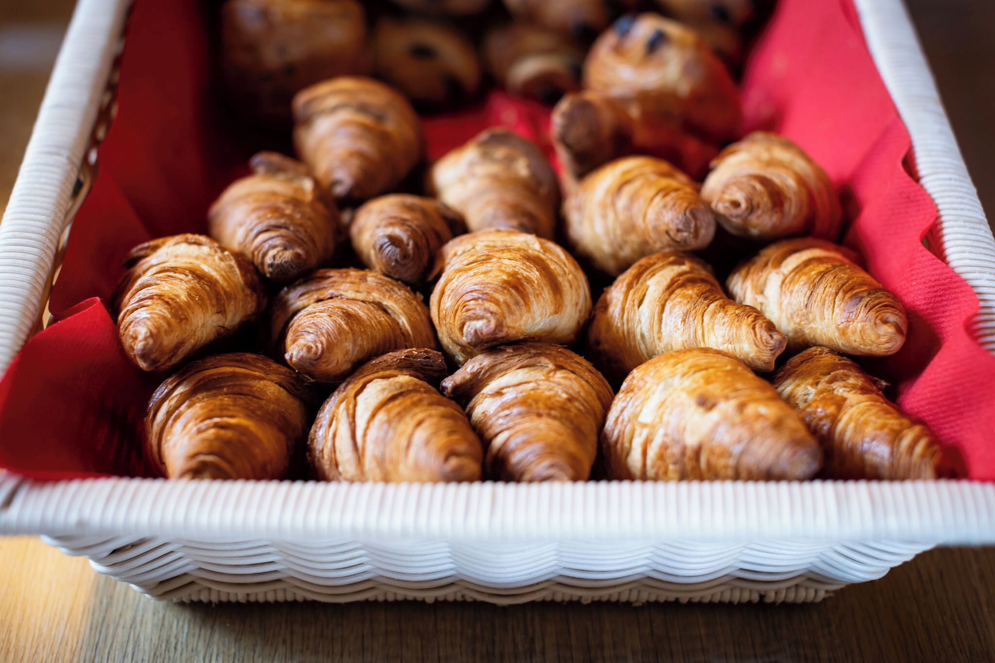 A basket filled with croissants.