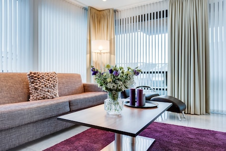 Deluxe Suite, 1 Bedroom, Balcony | Living area | LCD TV, heated floors