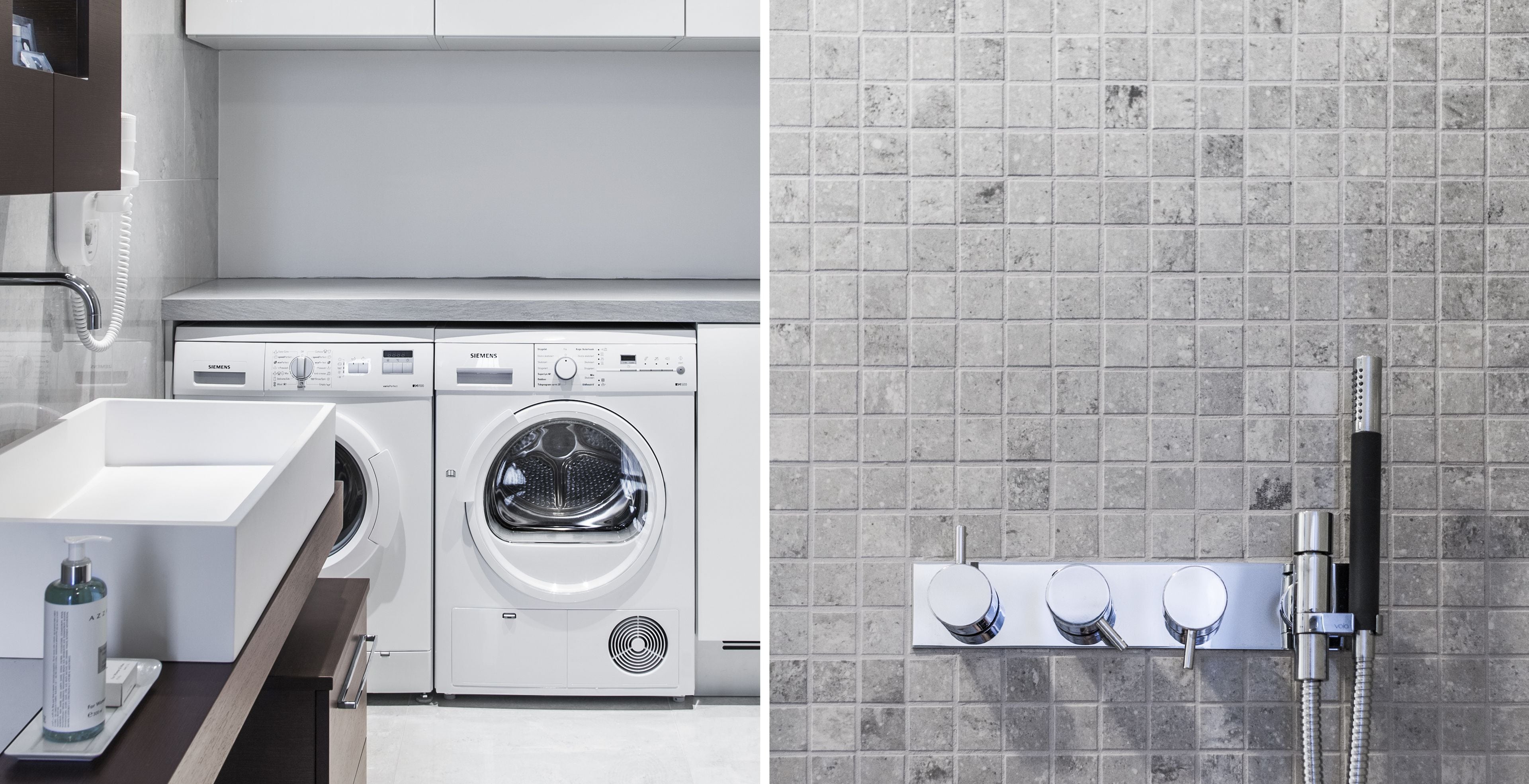 A modern bathroom with a built-in washing machine, a sink, and a shower with multiple controls.
