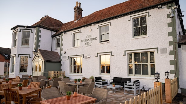 A traditional white building with the name "The Berkshire Arms" on the facade. It features outdoor seating with wicker furniture and potted plants. - Berkshire Arms by Chef and Brewer Collection (Reading)