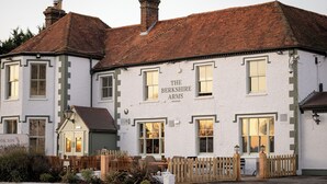 A traditional building with a sign reading 'The Berkshire Arms.' It features multiple windows, a wooden fence, and a small outdoor seating area. - Berkshire Arms by Chef and Brewer Collection (Reading)