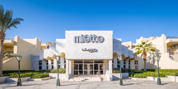 A modern building with a prominent 'miette' sign, featuring a clean, geometric facade and a central entrance. - Sunny Days Mirette Family Resort - All inclusive (Hurghada)
