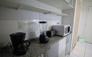 Full-sized fridge, microwave, stovetop, coffee/tea maker
