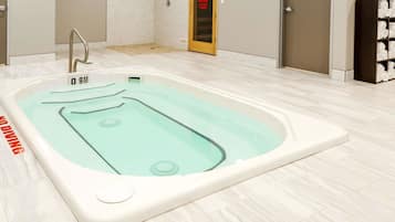 Relax in a spacious bathroom with a large bathtub and control panel for a comfortable stay.