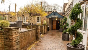 A stone building with an entrance labeled "Entrance," a brick pathway, and potted plants. - Cross Keys Hotel by Chef and Brewer Collection (Guisborough)