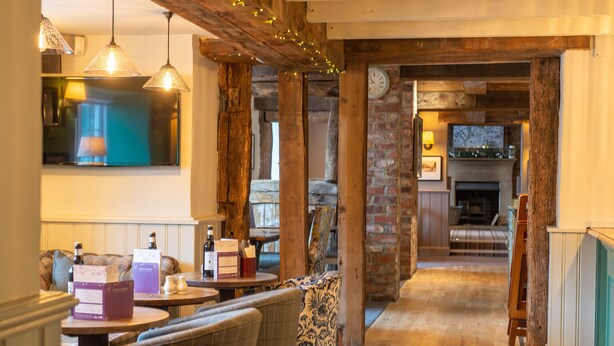 A cozy interior with wooden beams, a fireplace, and seating areas. - Cross Keys Hotel by Chef and Brewer Collection (Guisborough)