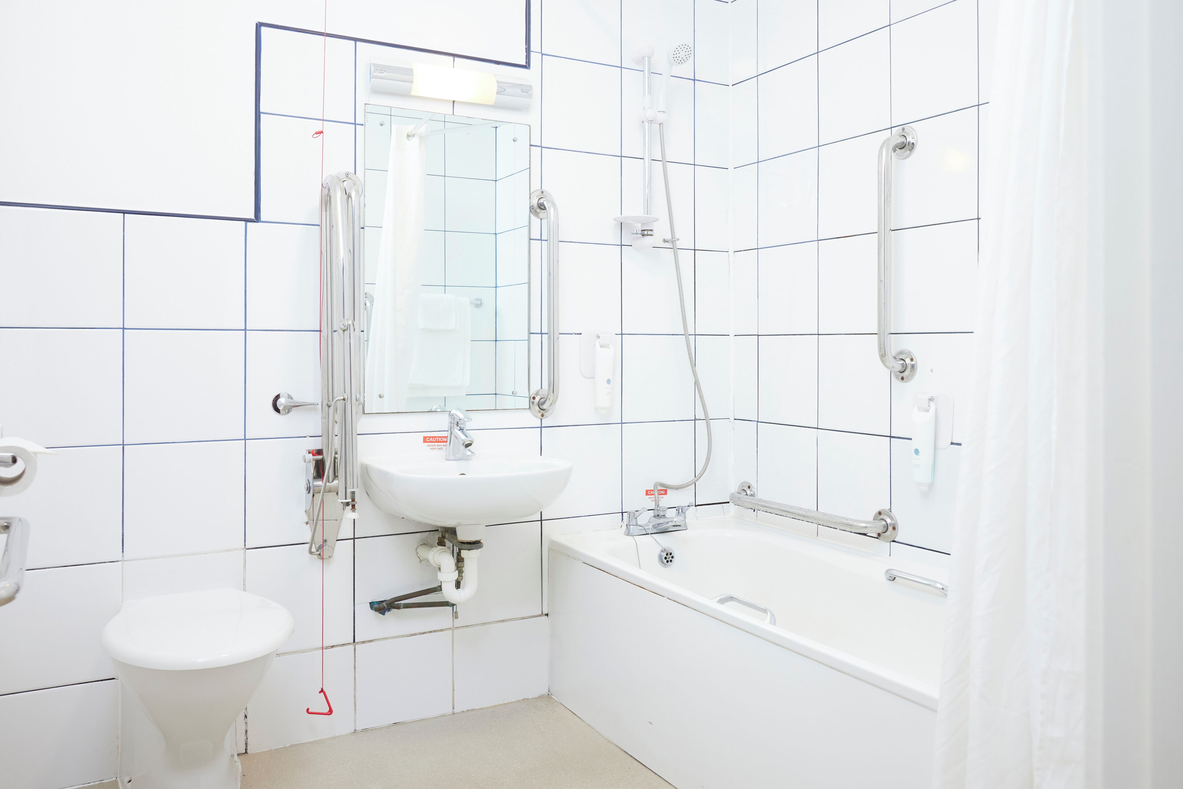 A bathroom with a toilet, sink, and bathtub.