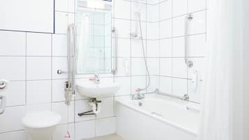 A bathroom with a toilet, sink, and bathtub.