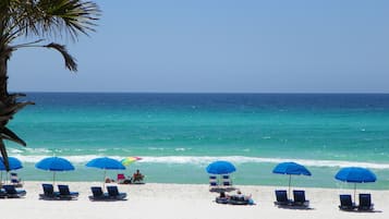 On the beach, white sand, beach cabanas, sun loungers