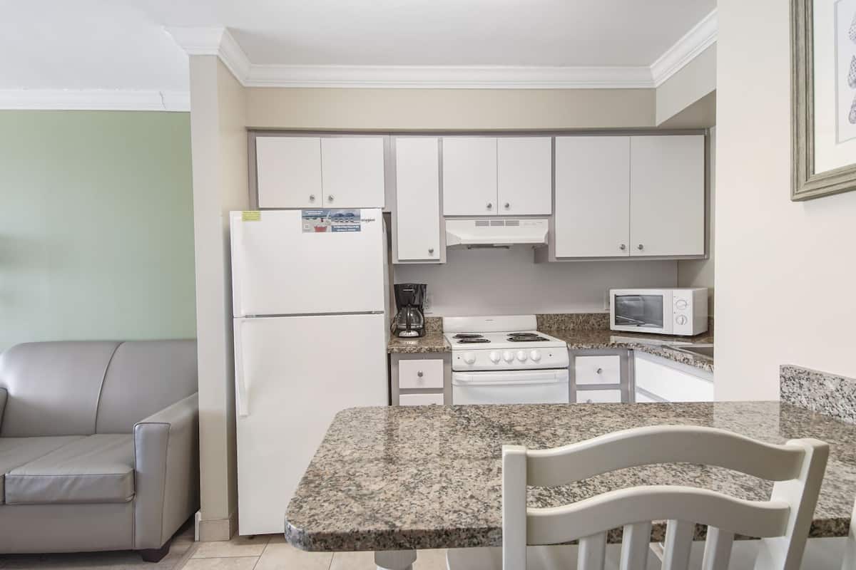 studio, 1 king bed with sofa bed, balcony, beach view | private kitchen | fridge, microwave, oven, stovetop