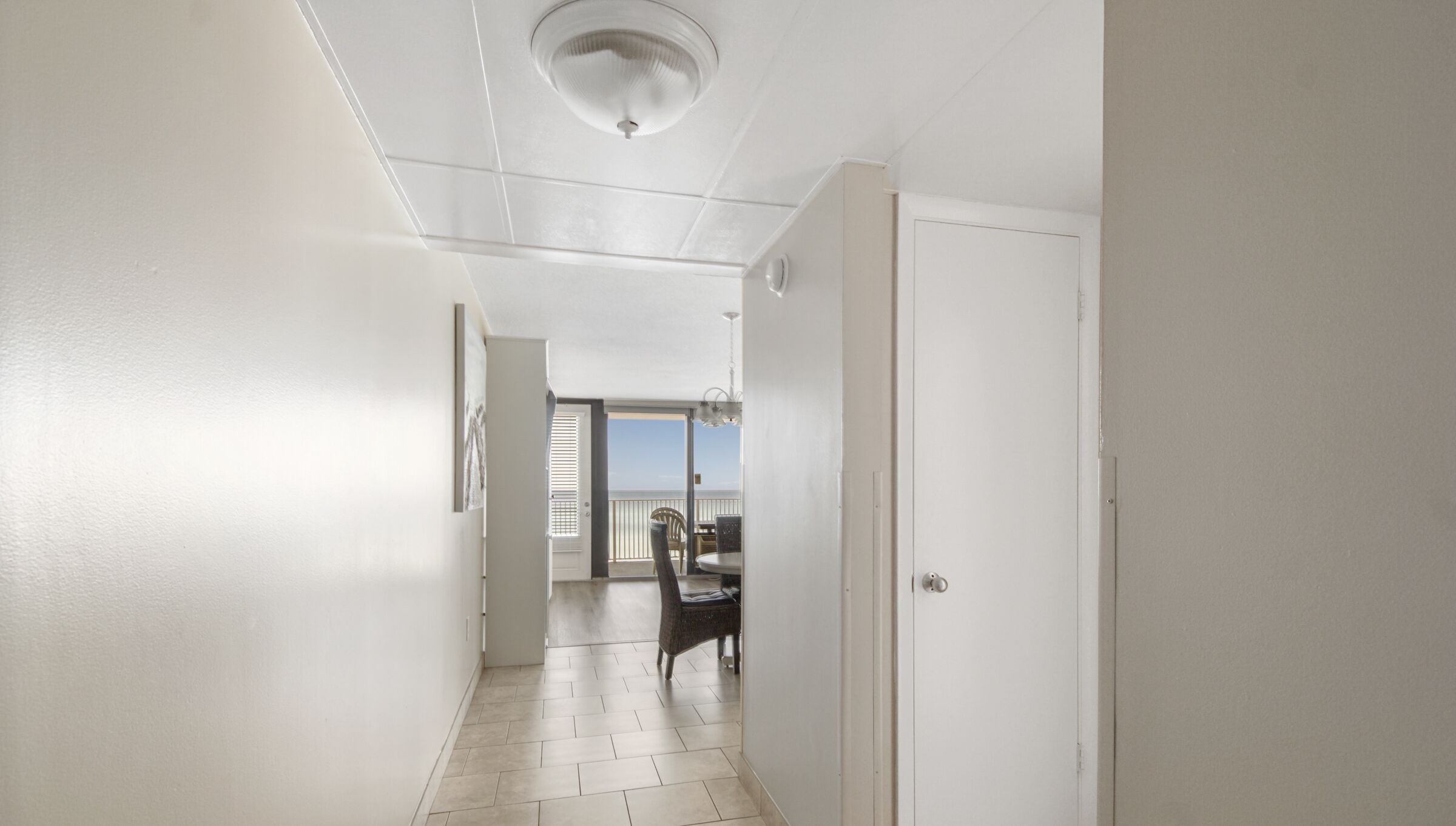 A hallway with a view to a balcony.