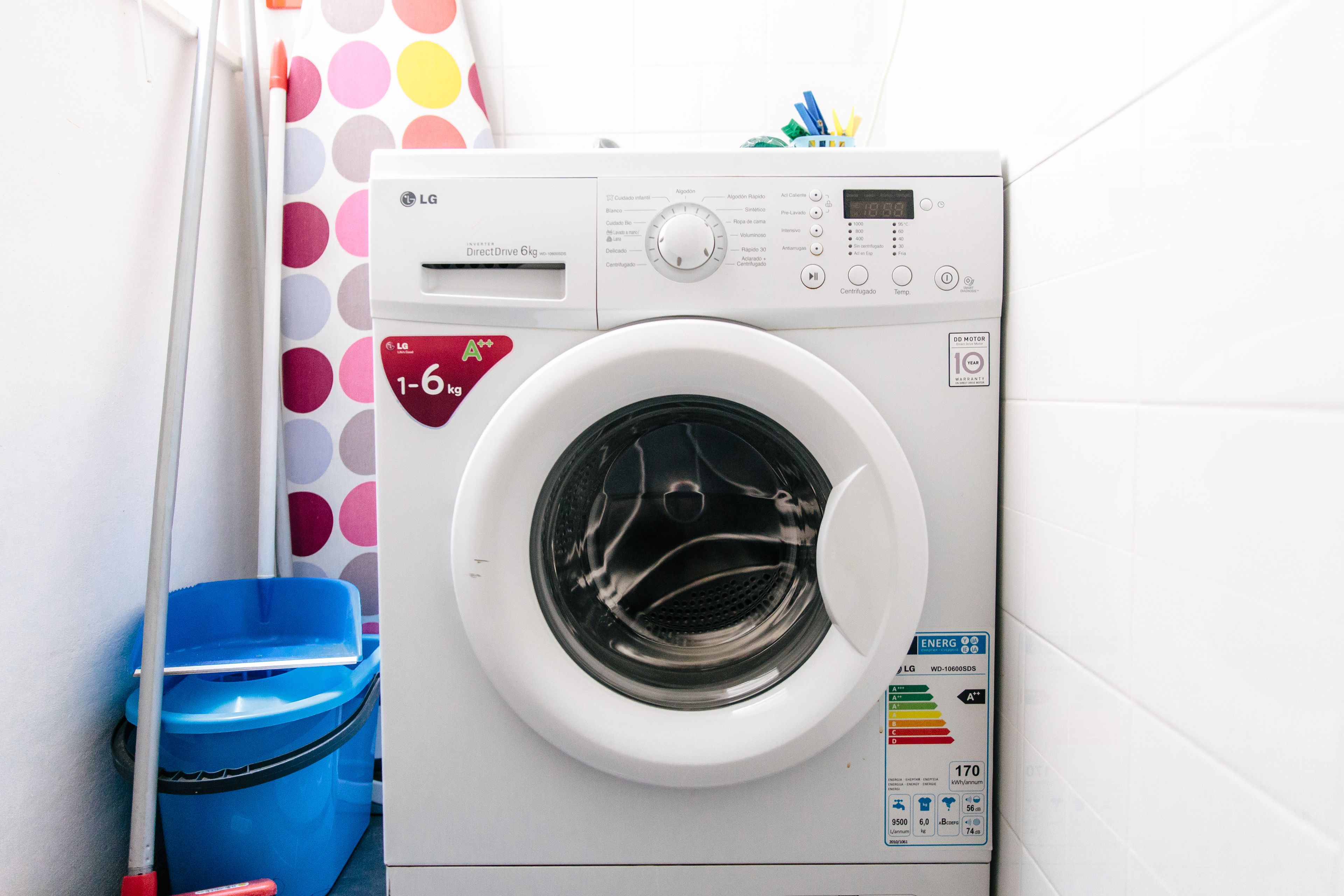 A front-loading LG DirectDrive 6kg washer with a digital display, control panel, and energy efficiency label.