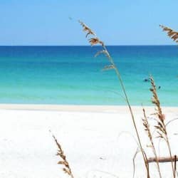 On the beach, white sand, sun-loungers, beach umbrellas