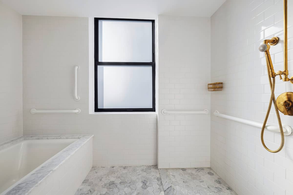 Suite, 1 King Bed, Accessible Bathtub (Mobility, Roll-In Shower) | Bathroom | Designer toiletries, hair dryer, bathrobes, towels