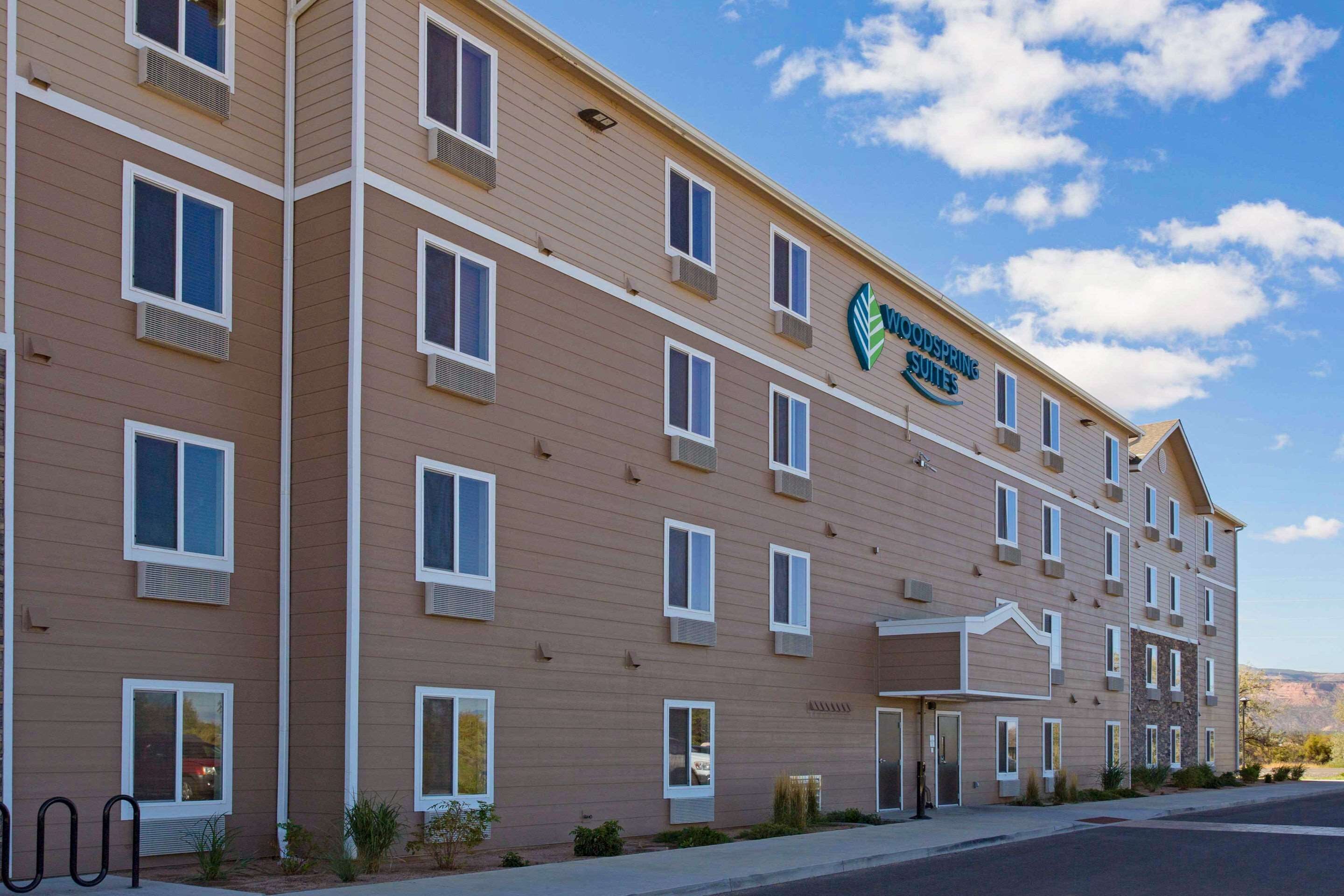 A multi-story hotel with a beige facade, multiple windows, and a visible entrance.