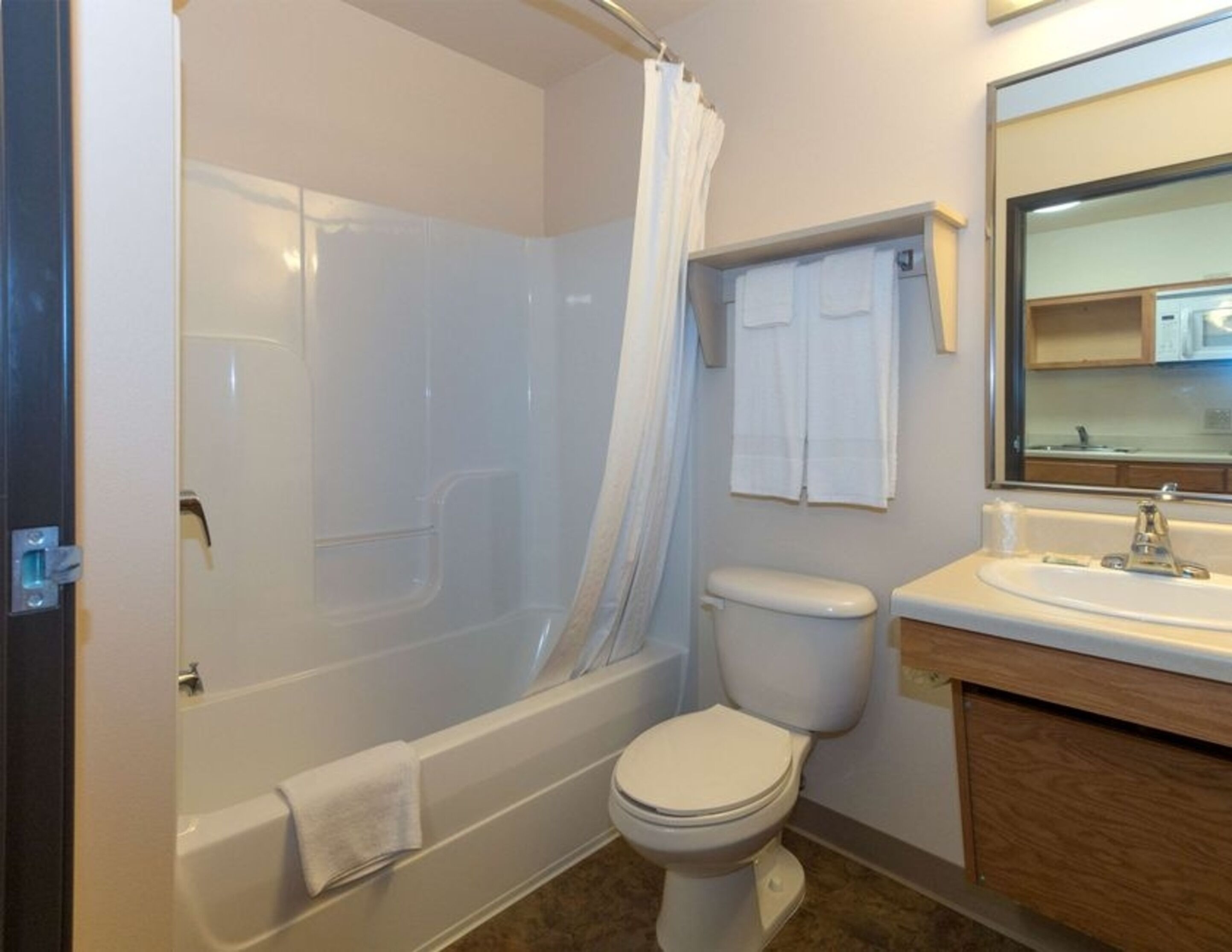 A bathroom with a bathtub, toilet, and sink.