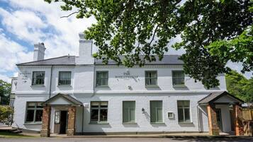 A white building with a sign reading "The Wheatsheaf."