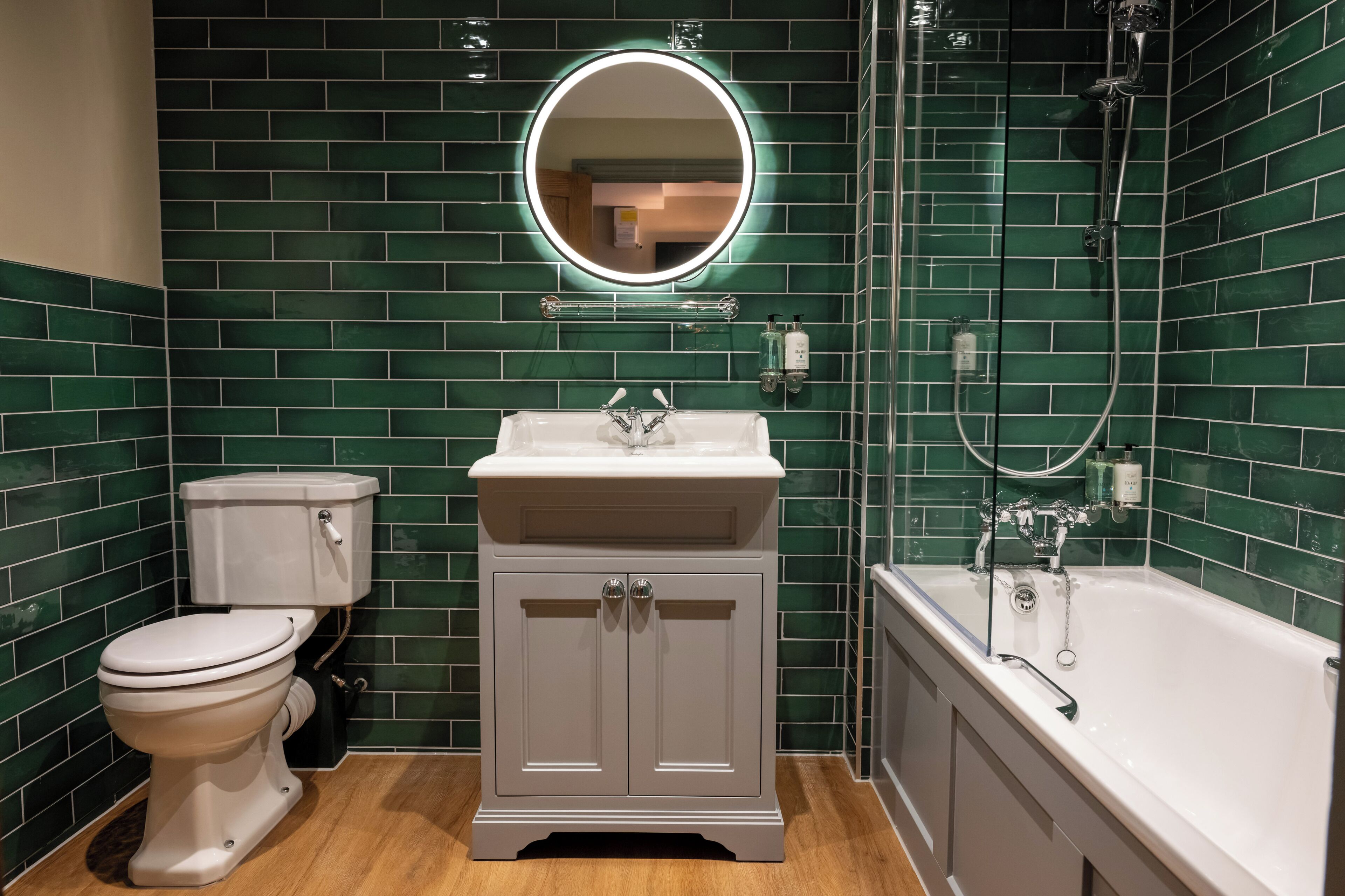 A bathroom with a toilet, sink, and bathtub, all with white fixtures.
