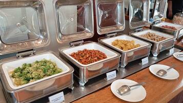 A buffet with labeled containers of various foods including broccoli, beans, and sweet soy sauce.