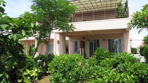 A two-story building with a flat roof and large windows. - Hibis Resort (Nakijin)