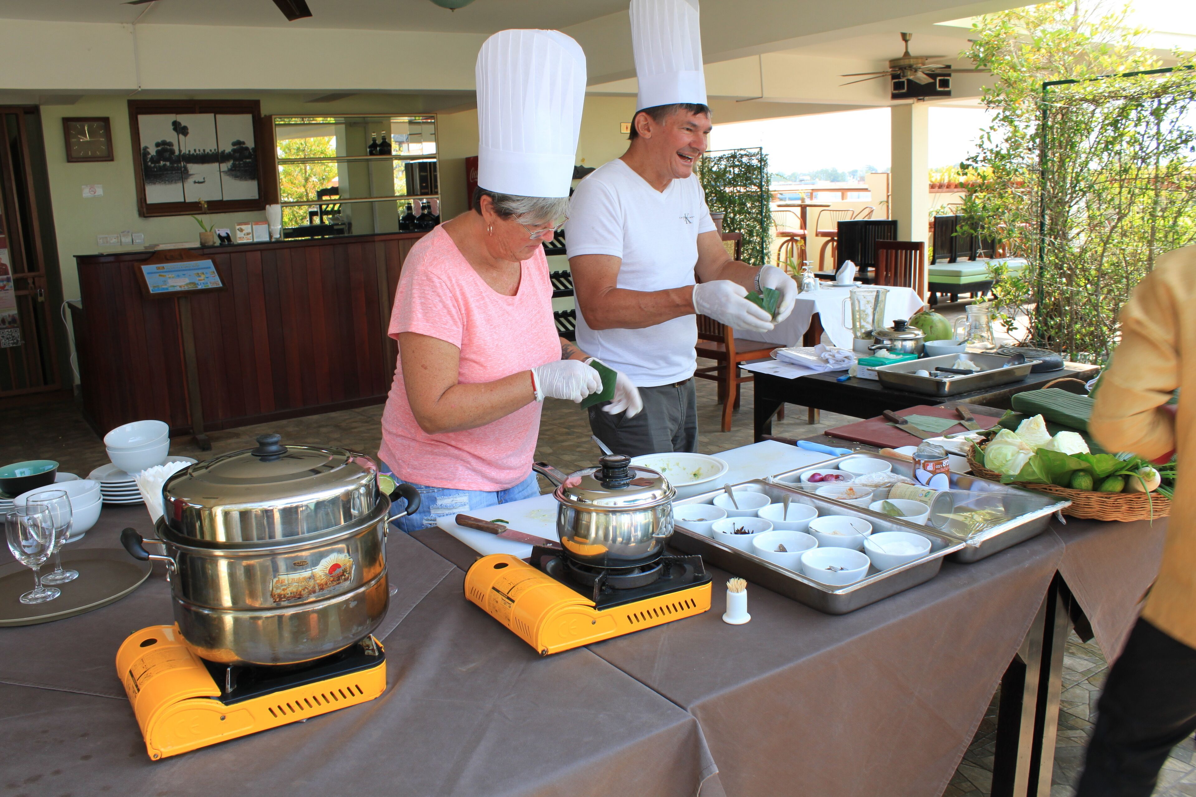 A buffet setup with a variety of dishes and a portable stove.