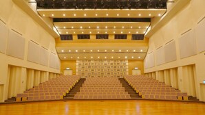 A large, multi-level auditorium with tiered seating and a central stage. - Chao She Hotel (Kaohsiung)