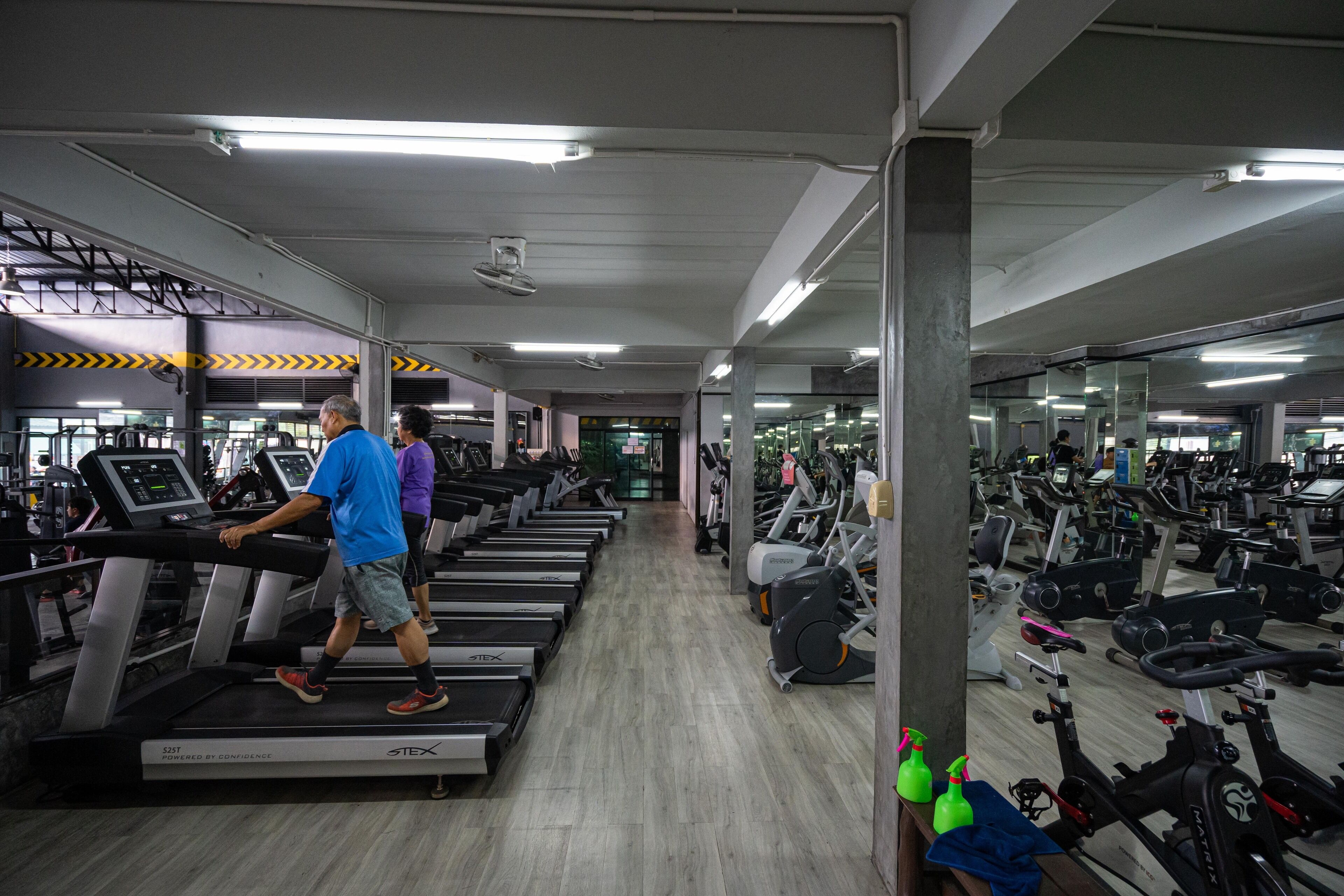 A gym with treadmills, stationary bikes, and other cardio equipment.