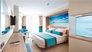Een moderne hotelkamer met een bed, bureau en televisie.