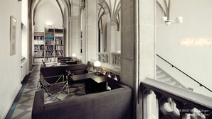 A library with high arched ceilings and bookshelves. There are seating areas with tables and chairs. - THE QVEST hideaway (Cologne)