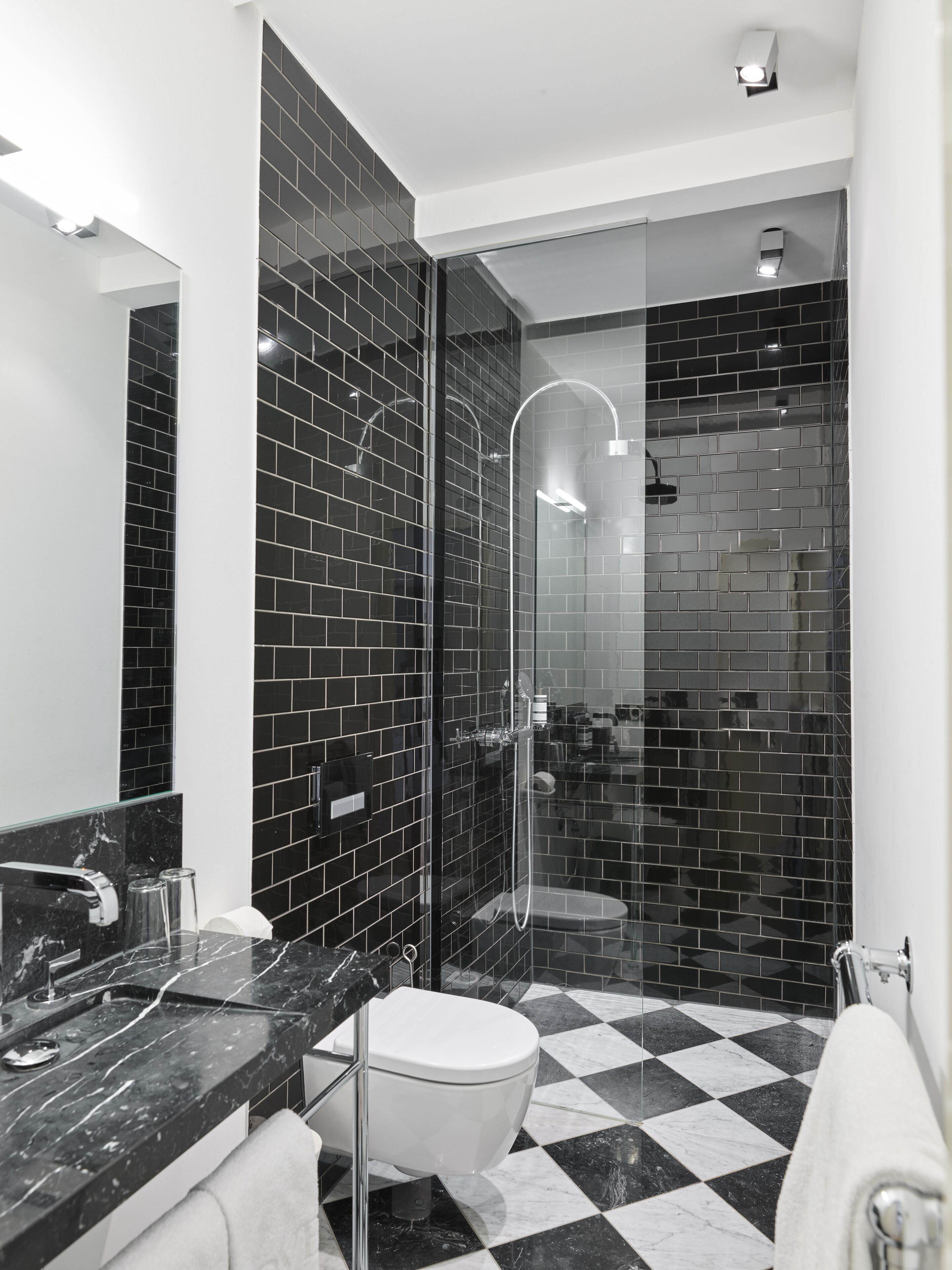 deluxe suite | bathroom | rainfall showerhead, eco-friendly toiletries, hair dryer, slippers